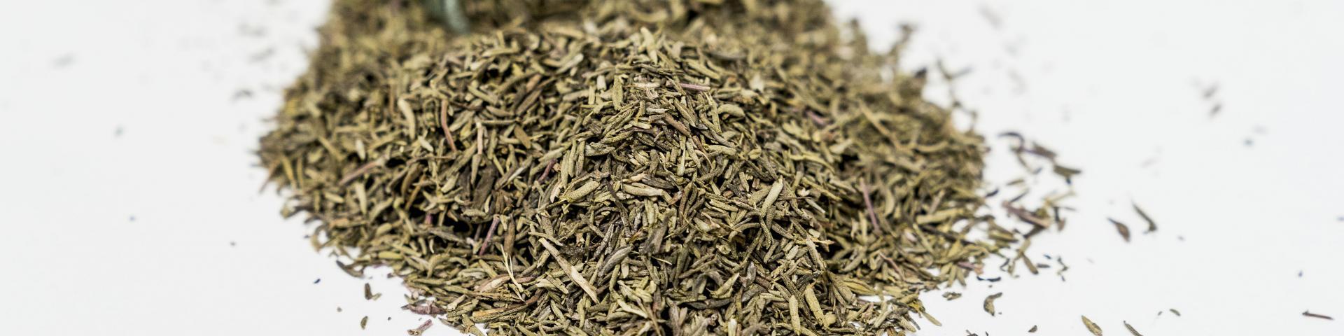 Dried thyme leaves against a white background
