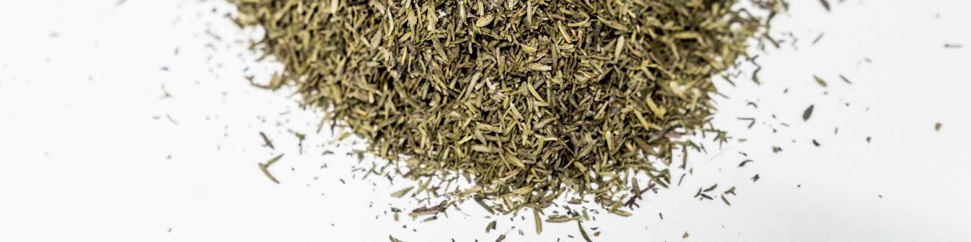 Dried thyme leaves against a white background