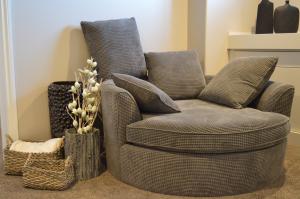 Snuggler-sized easy chair with matching cushions